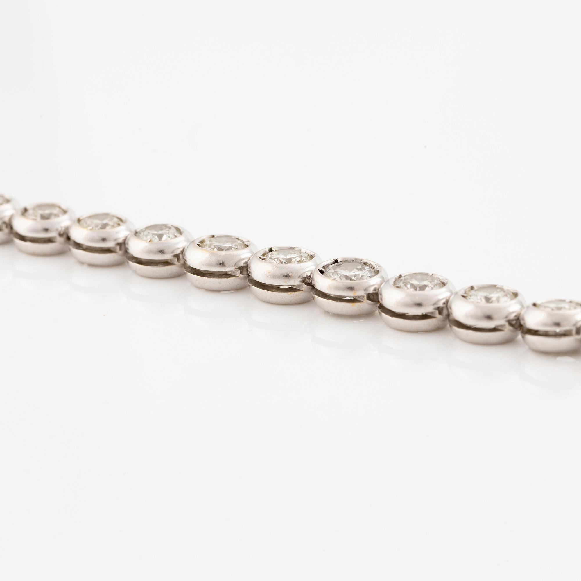 An 18K white gold bracelet set with round brilliant-cut diamonds.