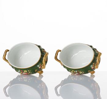 A pair of armorial butter tureens with covers and stands and two fruit dishes, Derby, England, circa 1830.