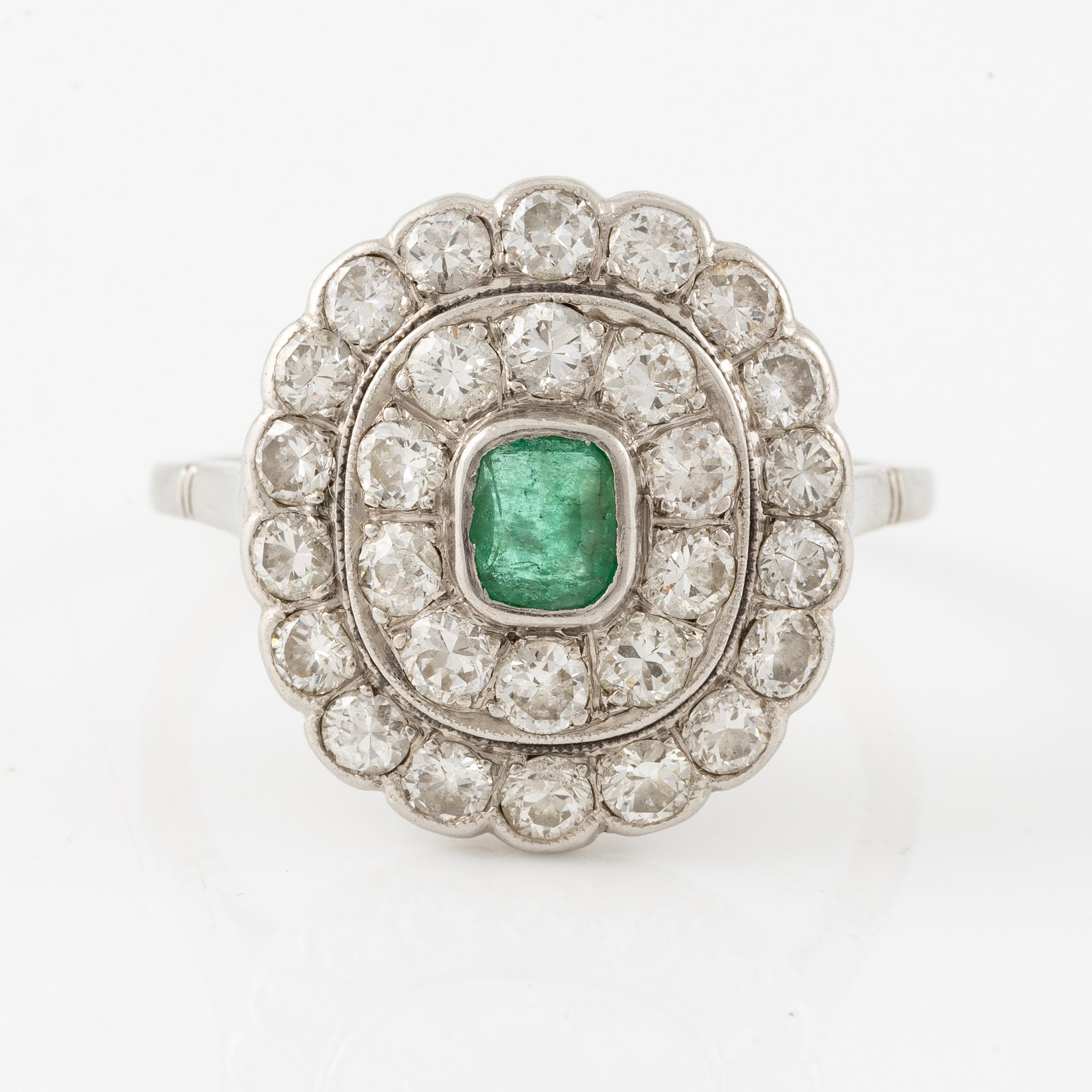 Platinum ring with an emerald and brilliant-cut diamonds.