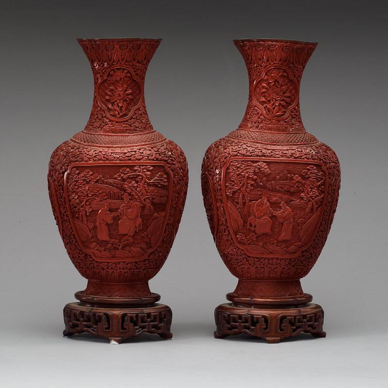 A pair of red lacquer vases, late Qing dynasty.