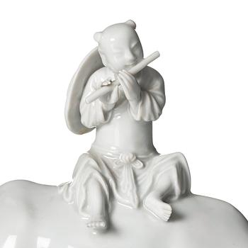 A blanc de chine figure of a boy on an ox, late Qing dynasty.