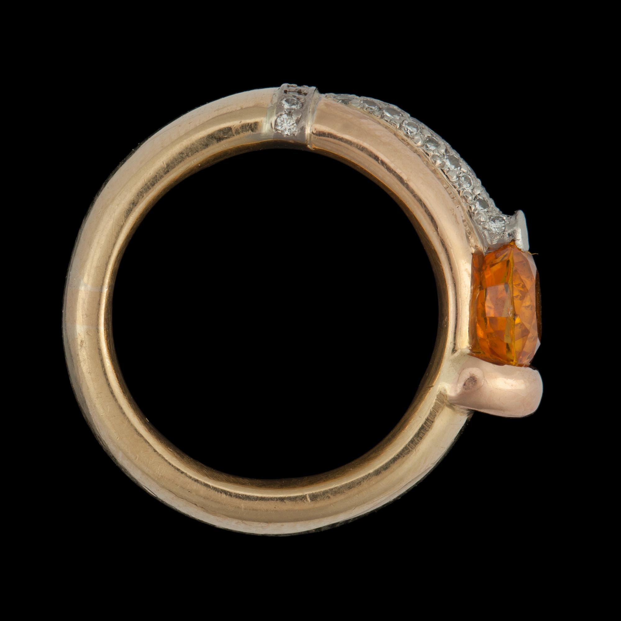A orange sapphire, circa 2.67 cts, and diamond, 0.32 ct, ring.