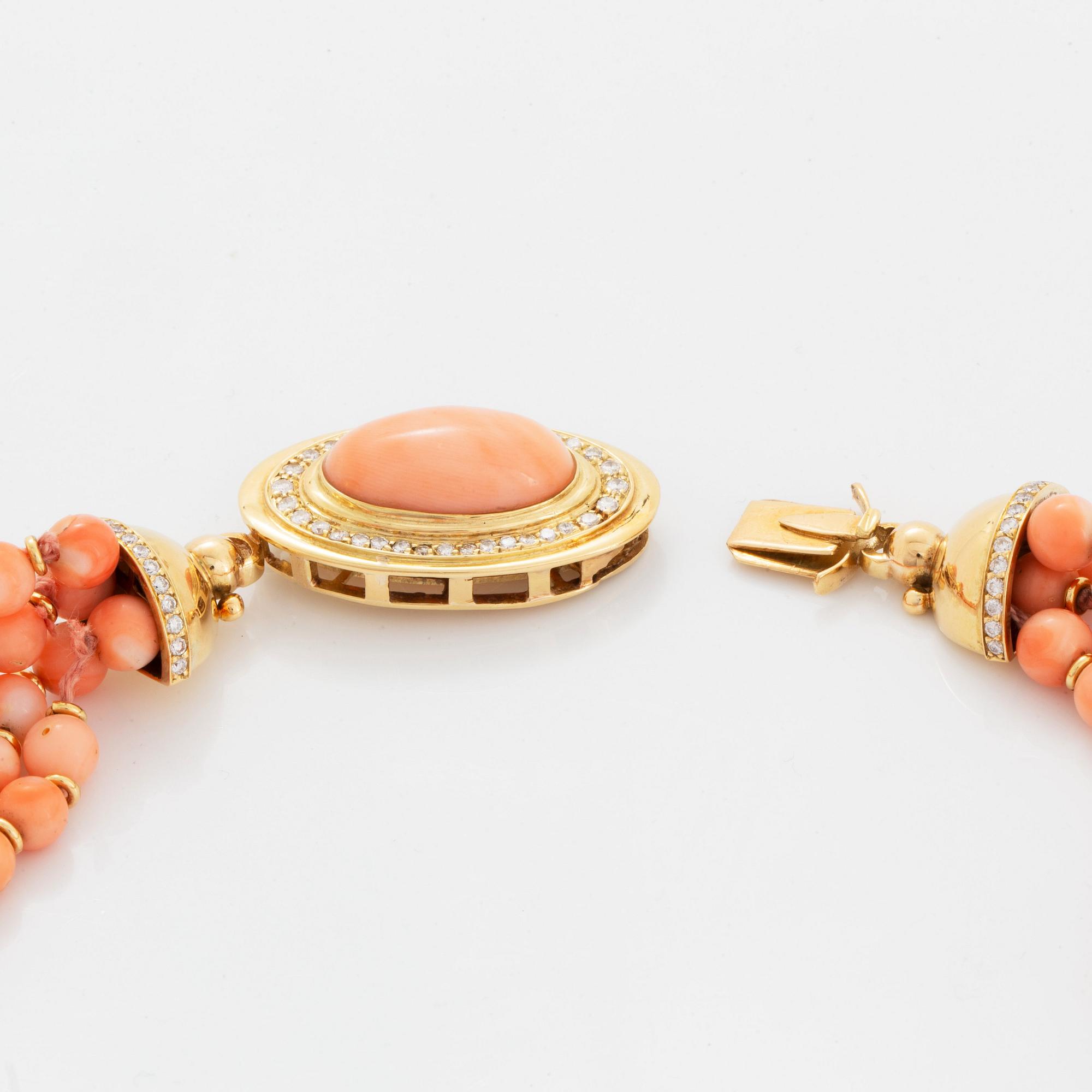 A four strand coral necklace with an 18K gold clasp set with coral and round brilliant-cut diamonds.
