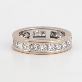 An 18K white gold eternity ring set with princess-cut diamonds.