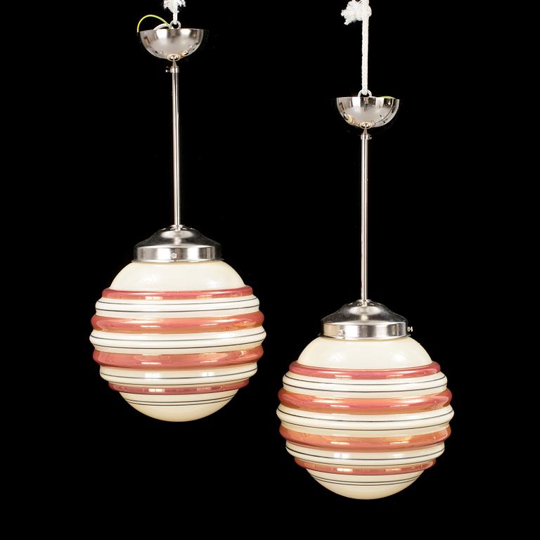 A pair och metal and and glass ceiling lights from the 1940s. Height ca 59 cm.