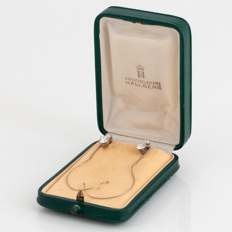 A pair of platinum earrings set with old-cut diamonds with a total weight of ca 1.70 cts.