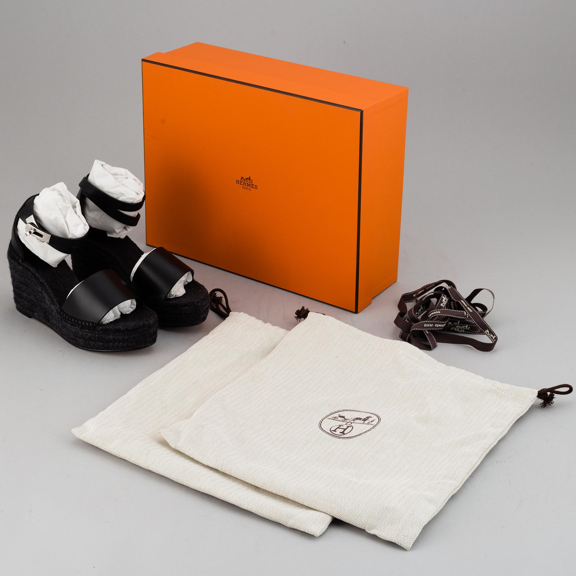HERMÈS, a pair of black leather 'Tivoli' wedge sandals, 2019, size 38.