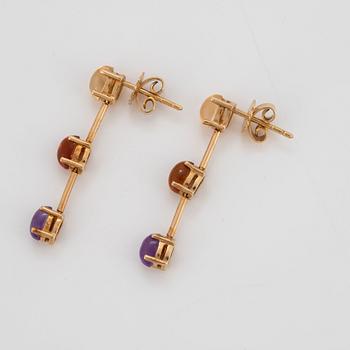 A pair of 18K gold earrings set with cabochon-cut citrines and amethysts.