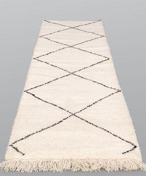 A Moroccan runner carpet, 300 x 88 cm.