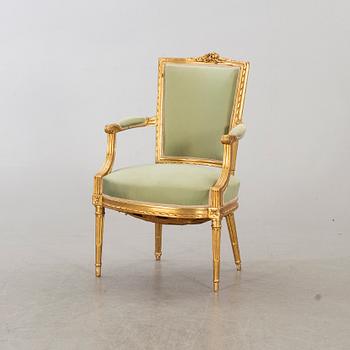 A Louis XVI-style arm chair, ca 1900.