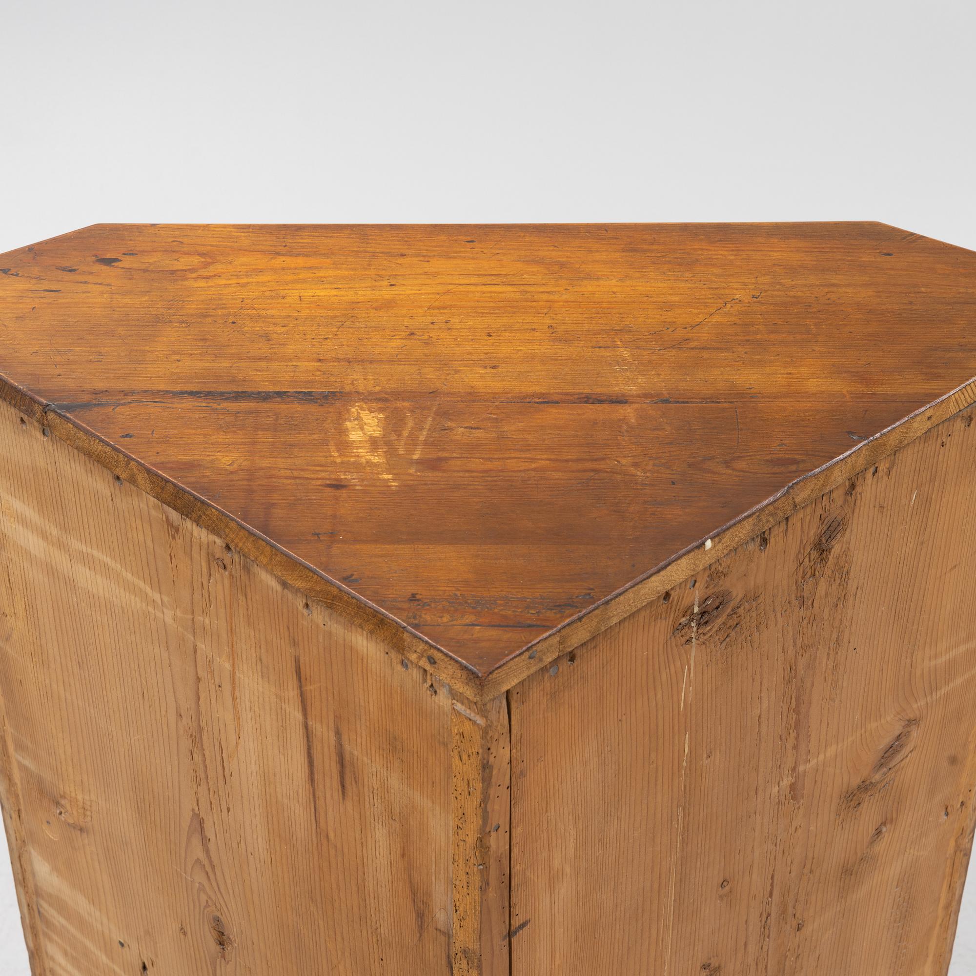 A Gustavian style pinewood corner cupboard, 19th Century.
