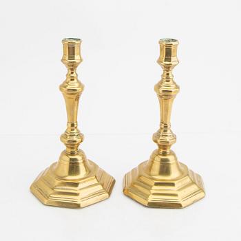 A pair of 18th century brass candle sticks.