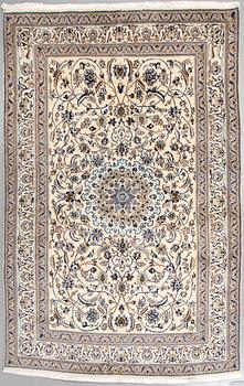 A Nain rug, part silk, 296 x187 cm.