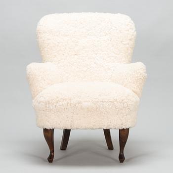 A contemporary sheepskin upholstered lounge chair, ABC collection.
