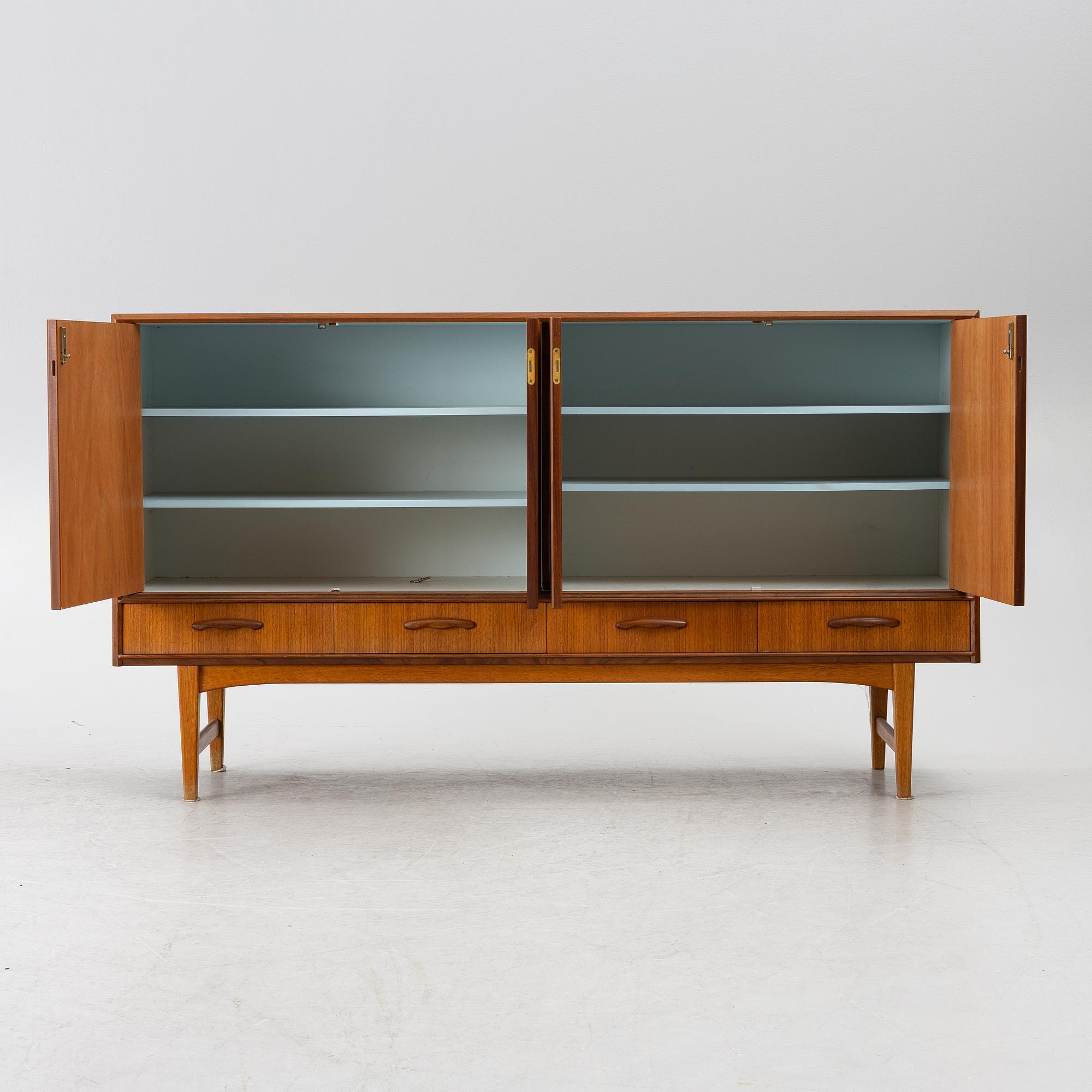 A mid20th century teak-veneered sideboard.