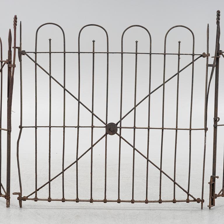 A pair of iron garden gates and a single gate from the early 20th century.