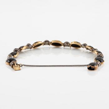A necklace/bracelet combination 18K gold and silver set with onyx and rose-cut diamonds, 19th century.