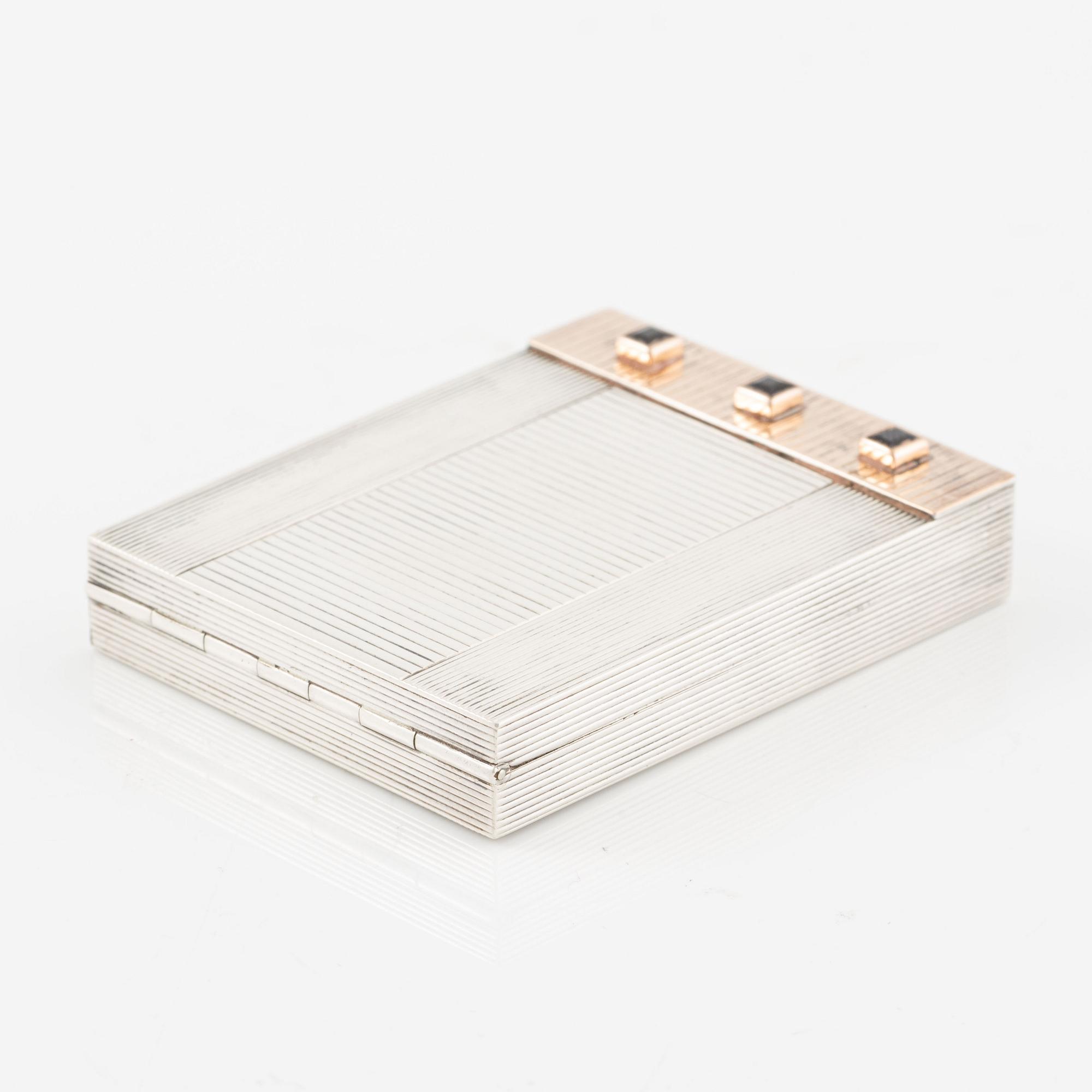 Powder box, signed Cartier, sterling silver and 14K gold with three sapphires.