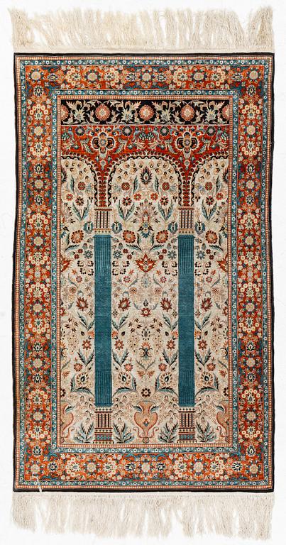 An oriental silk rug, probably China, c. 154 x 93 cm.