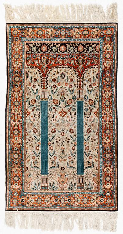 An oriental silk rug, c. 154 x 93 cm.