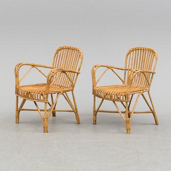 A pair of mid 20th century bamboo and rattan easy chairs.