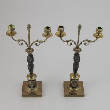 A pair of brass Empire style candle holders, 20th century.
