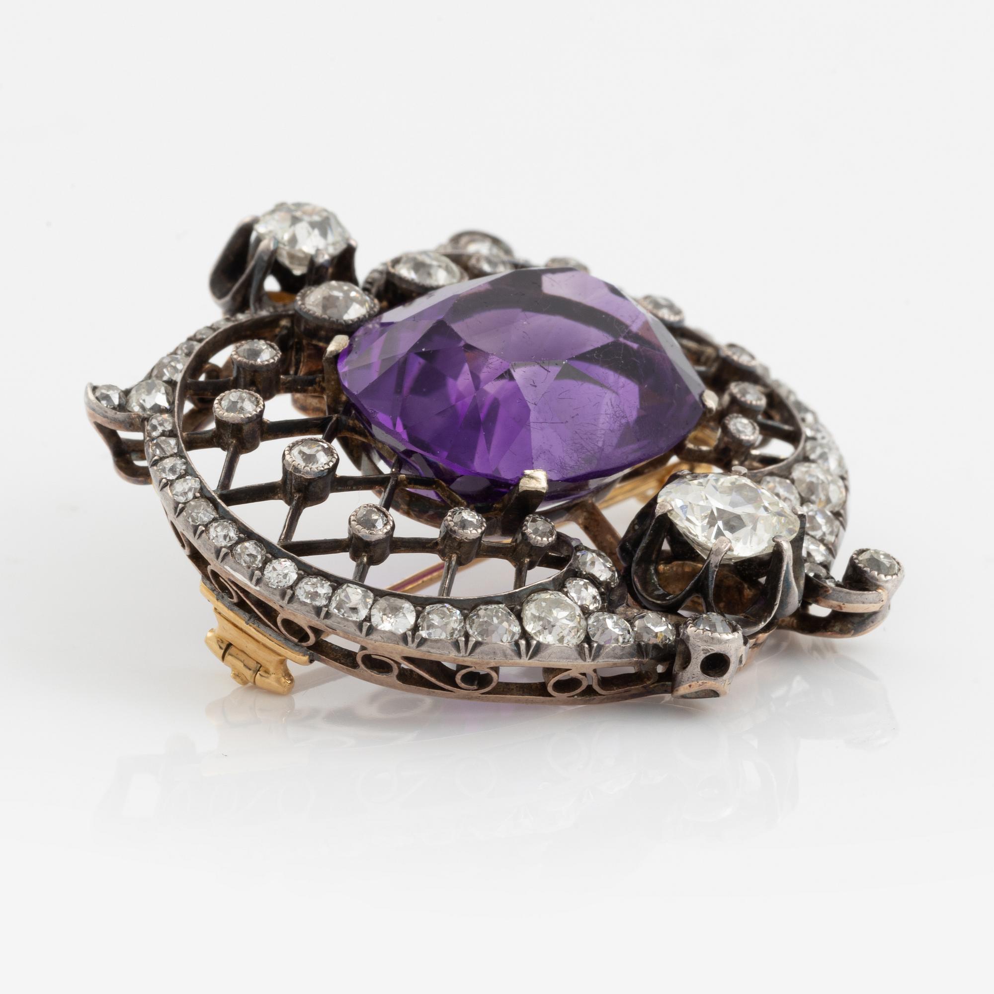A brooch set with an amethyst and old-cut diamonds.