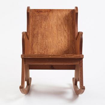 Nordiska Kompaniet, a Swedish Modern stained pine 'Lovö' rocking chair, 1940s.