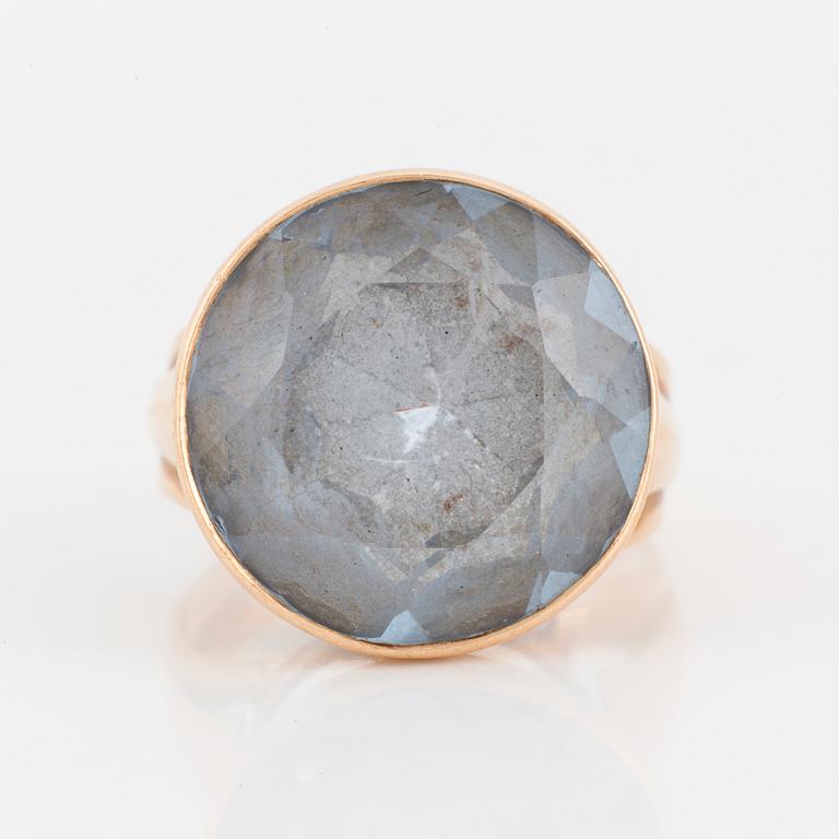 A 14K gold and synthetic blue spinel ring.