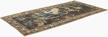 A 17th century Flemish 'verdur' entre-fenêtre tapestry, c. 268 x 130 cm.