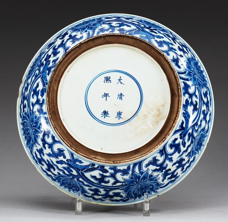 A large blue and white charger, Qing dynasty, with Kangxis six character mark and period (1662-1722).