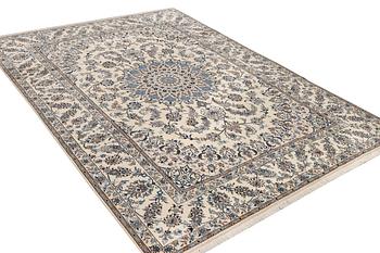 A Nain, part silk carpet, c. 337 x 244 cm.