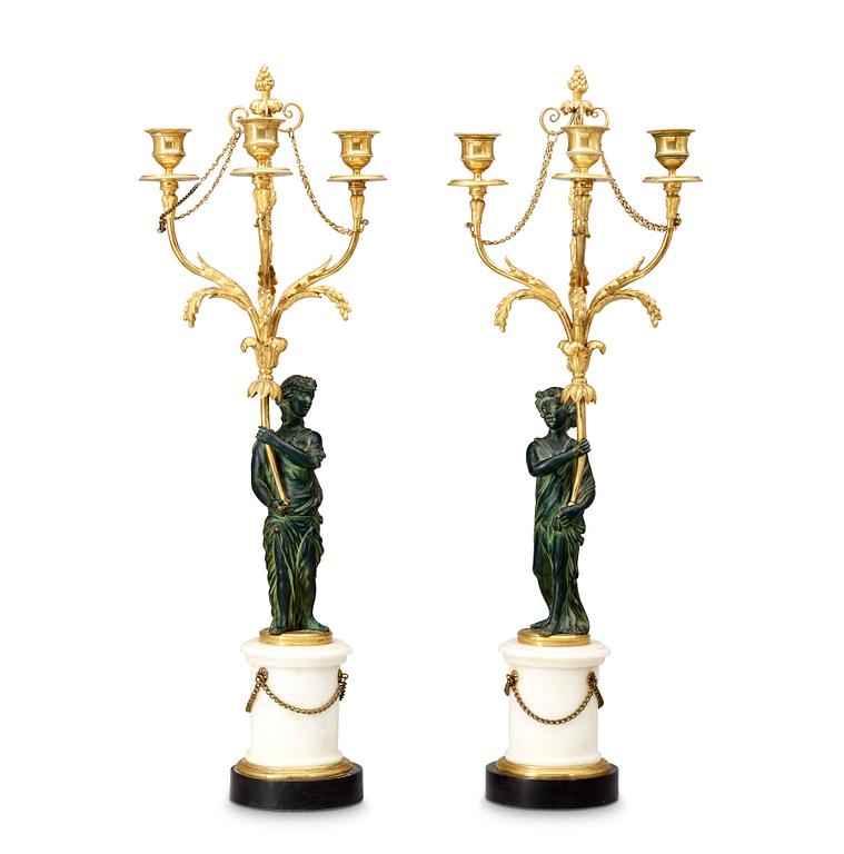 A pair of Louis XVI 18th century gilt and patinated bronze and marble three-light candelabra.