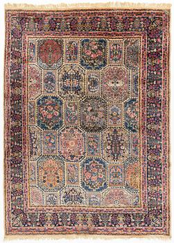 An carpet, possibly Kirman, signed, 350 x 255 cm.