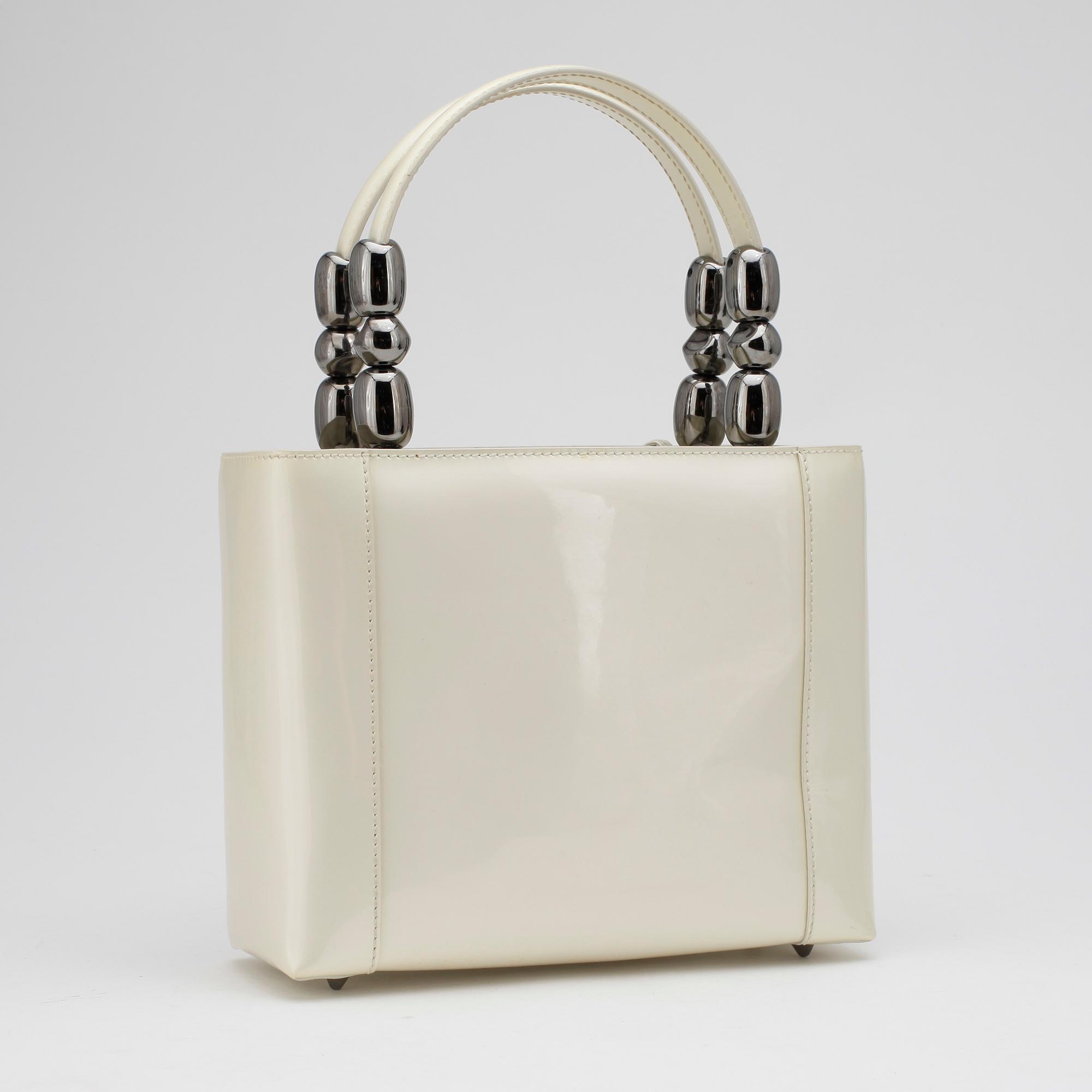 CHRISTIAN DIOR, a white patent leather handbag.