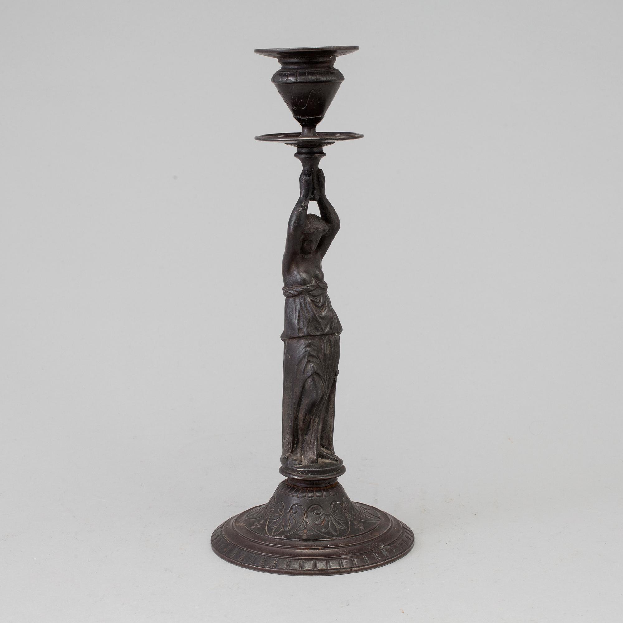 A 19th century iron candlestick marked F.L Vombach Offenbach A/M.