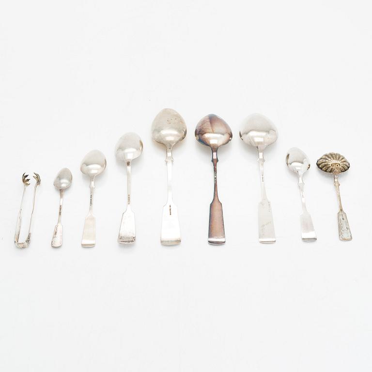 Silver spoons, 29 pcs, and sugar tongs with shell motif mostly by Kuopion Kultaseppä oy, Kuopio, 1919-53.