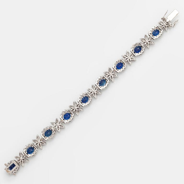 A platinum bracelet, set with oval faceted sapphires and brilliant-, marquise-, and single-cut diamonds.