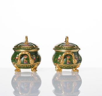 A pair of armorial butter tureens with covers and stands and two fruit dishes, Derby, England, circa 1830.