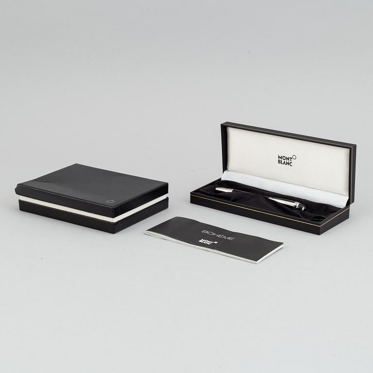 MOntblanc, a ball point pen and leather passport holder.