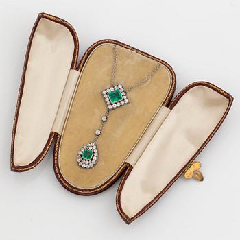 A necklace set with two faceted emeralds and old-cut diamonds.