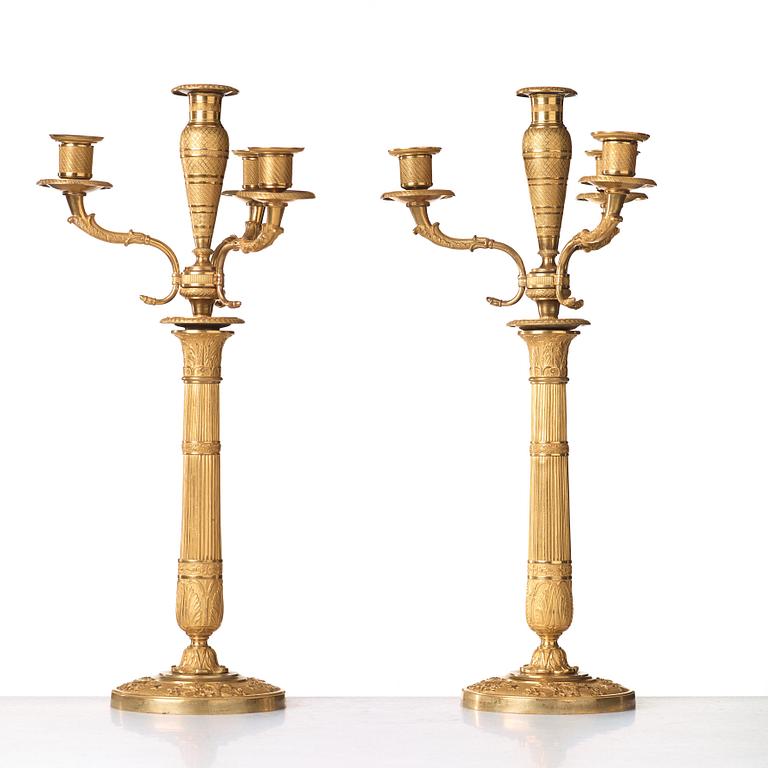 A pair of Empire early 19th century gilt bronze four-light candelabra.