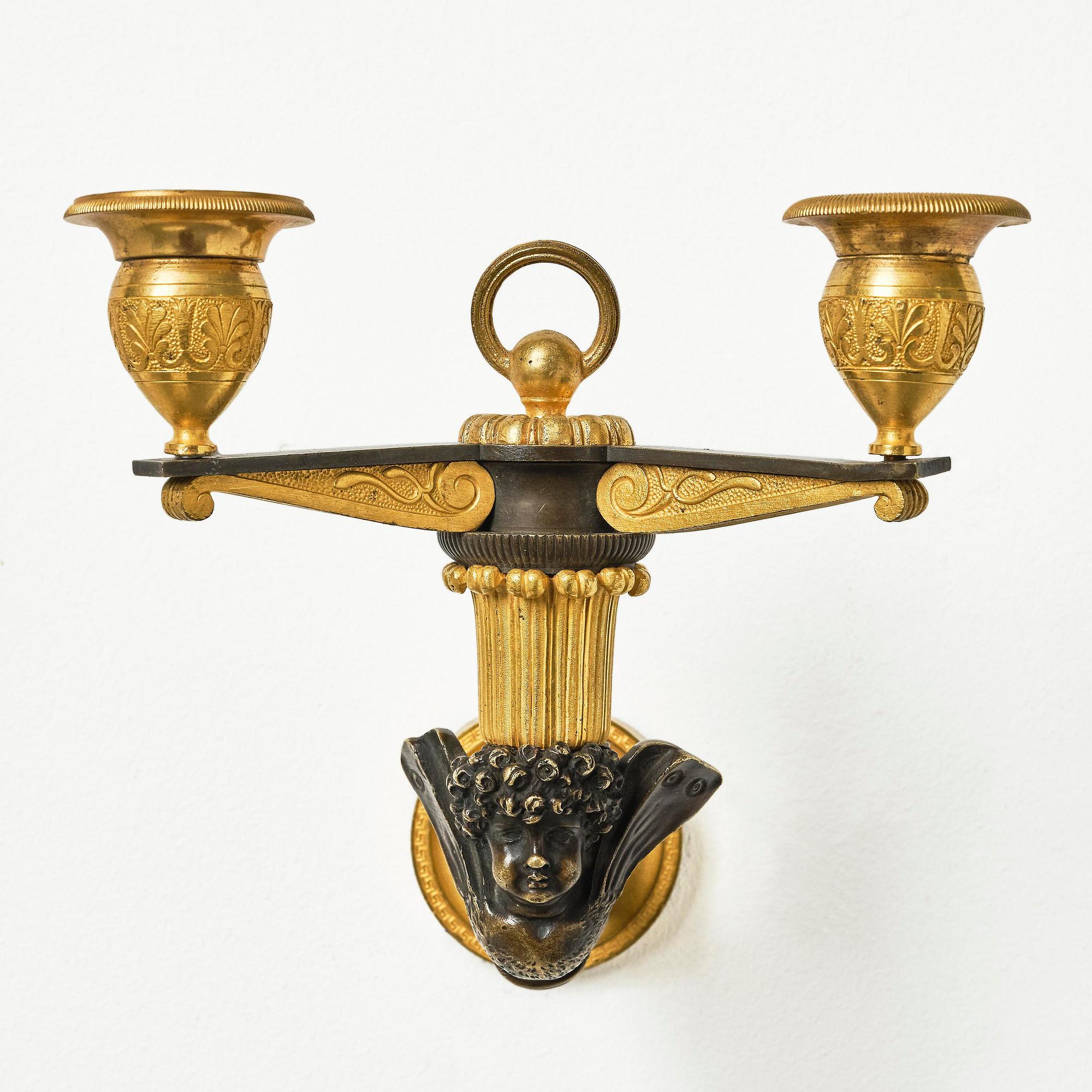 A pair of Empire patinated and ormolu two-branch appliques attr. to C. Galle (bronzier in Paris 1786-1815).