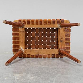 A leather upholstered stool, 1950's.