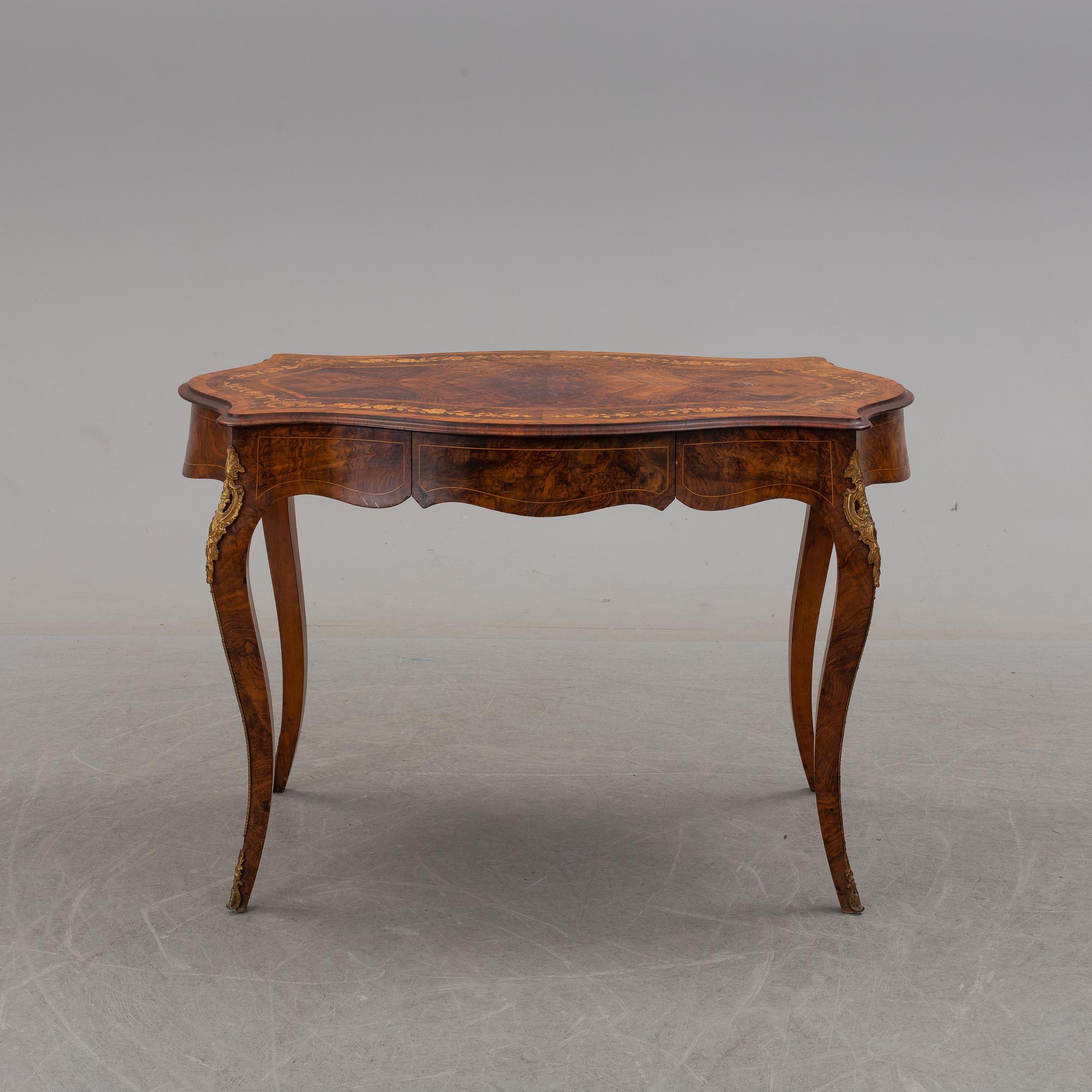 a rococo-style table/desk from England in the late 19th century.
