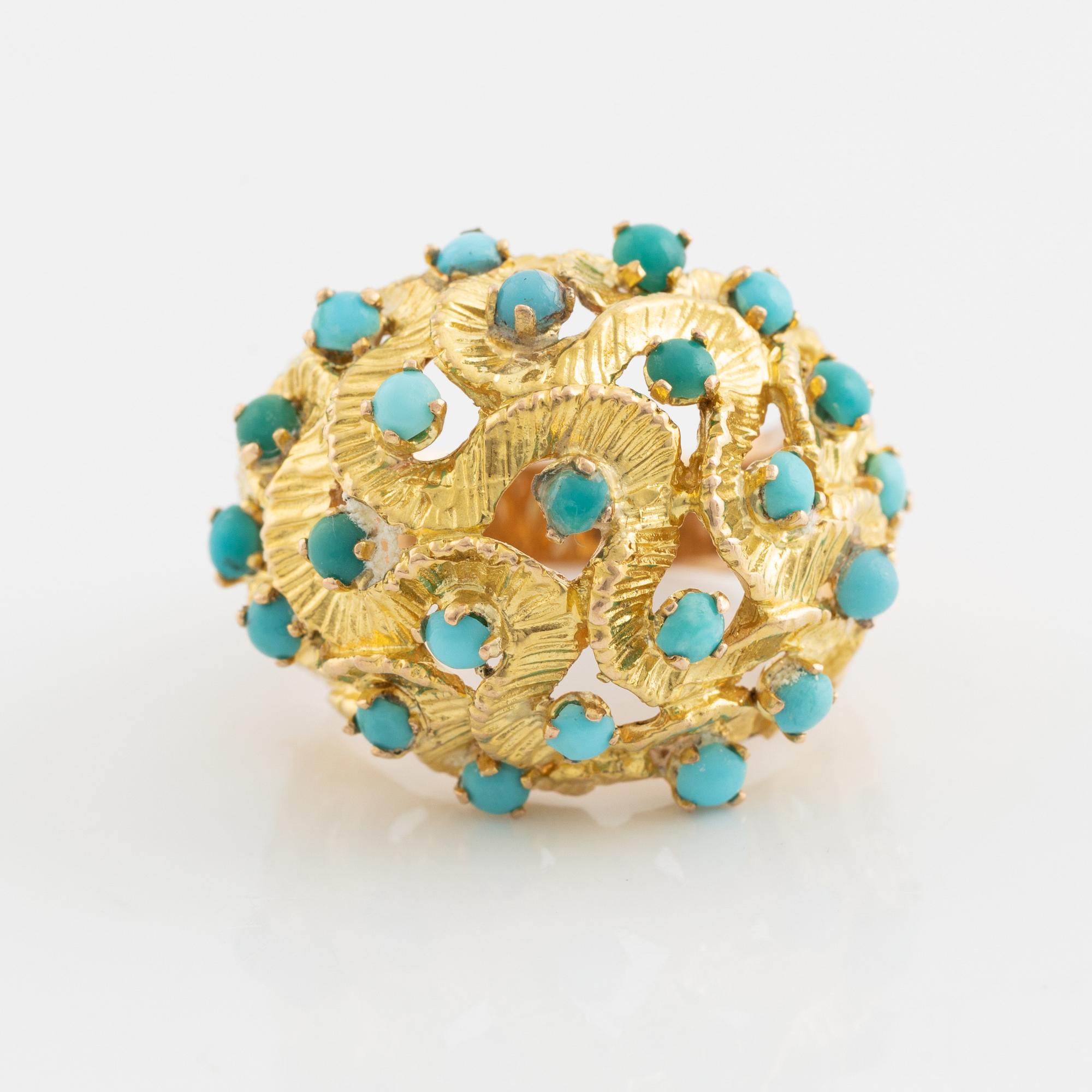 A 14K gold ring set with turquoises.