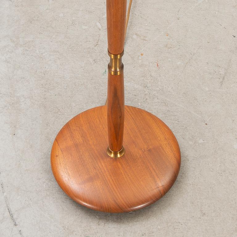 A 1960s brass and teak floor lamp.