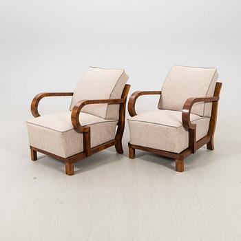 A pair of walnut Art Deco armchairs.