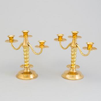 a pair of brass candelabras by Gottfrid Carlsson Eskilstuna.