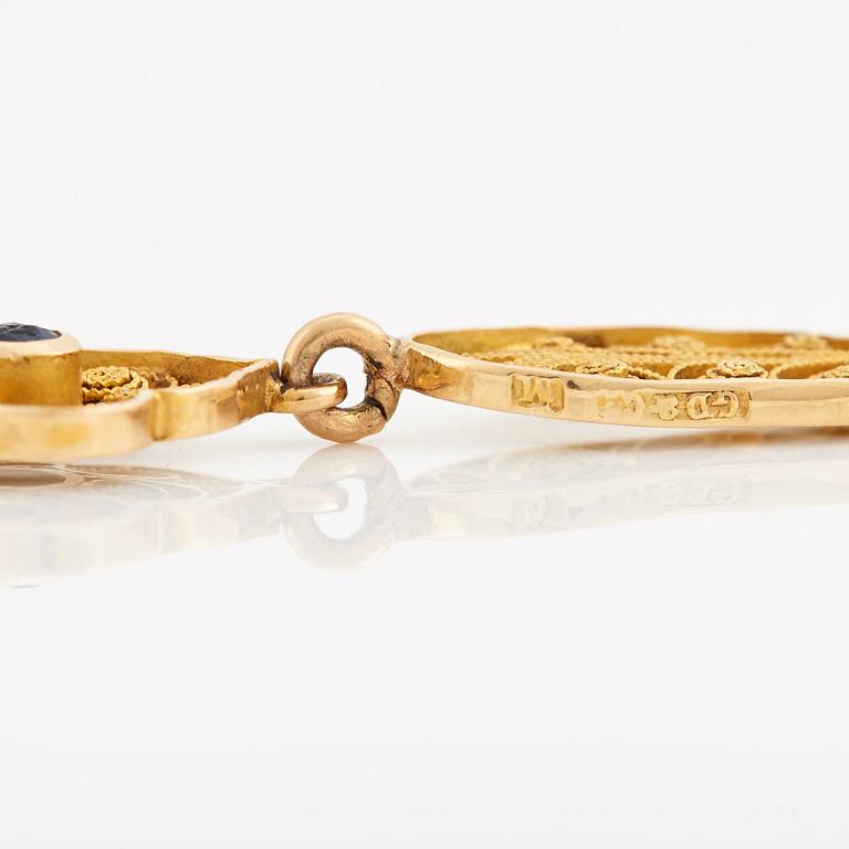 A necklace set with seed pearls, a cabochon cut sapphire, probably another sapphire and filigree work.